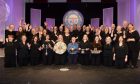 Oban Gaelic Choir (centre) with the Lovat and Tullibardine Shield, the premier trophy for area choirs at the Royal National Mod.