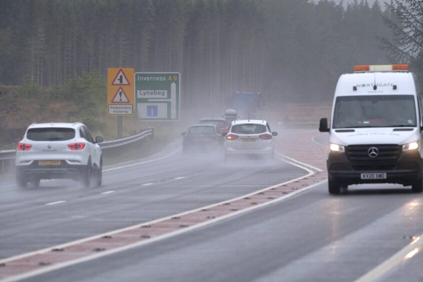 Vehicles travelling in rainy conditions on A9