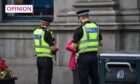 Two police officers speaking to someone in Aberdeen city centre