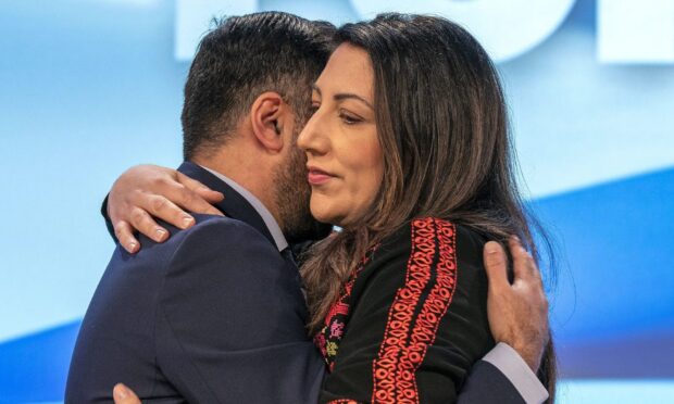 First Minister and SNP leader Humza Yousaf embraces his wife councillor Nadia El-Nakla after she spoke on an emergency motion on Israel-Palestine during the SNP annual conference at The P&J Live in Aberdeen. Image: PA.