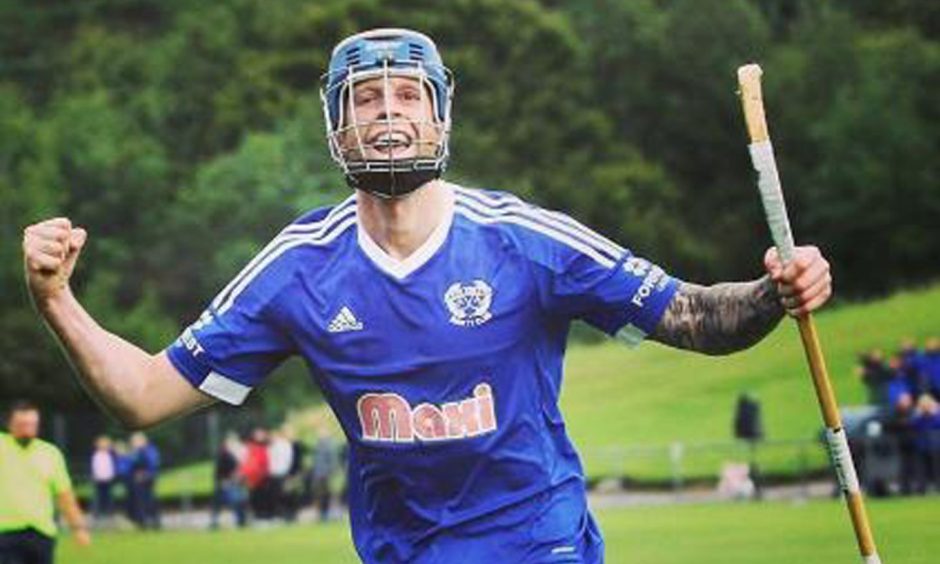 Roddy MacDonald smiling as he plays for Kyles Athletic. Image: supplied by Camanachd Association.