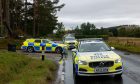 A number of police cars lined up along the A93 near Aboyne.