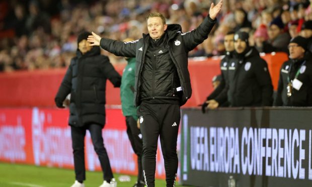Aberdeen manager Barry Robson reacts on the sideline during the Europa Conference League game with PAOK. Image: PA.
