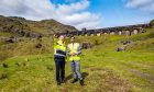 Humza Yousaf at SSE Sloy Announcement standing in a field wearing yellow vest.