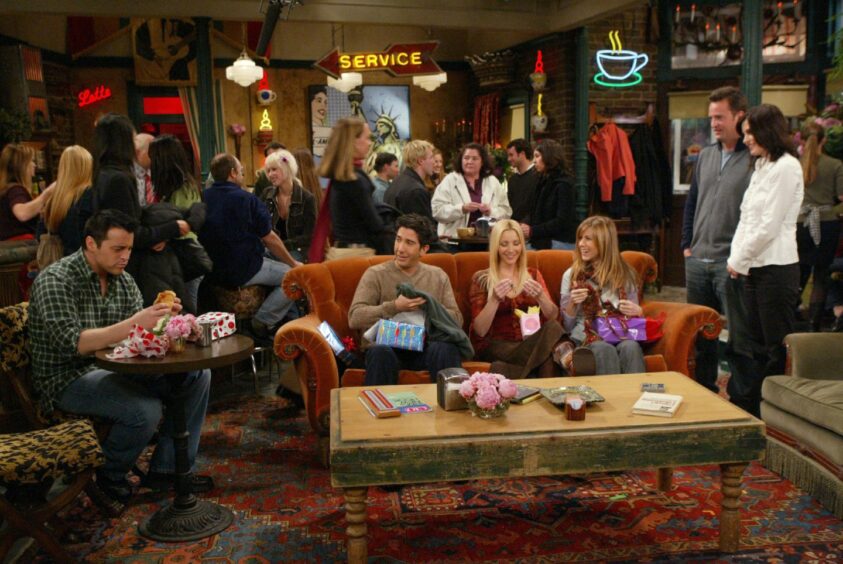 The Friends cast during a scene at Central Perk coffee shop.
