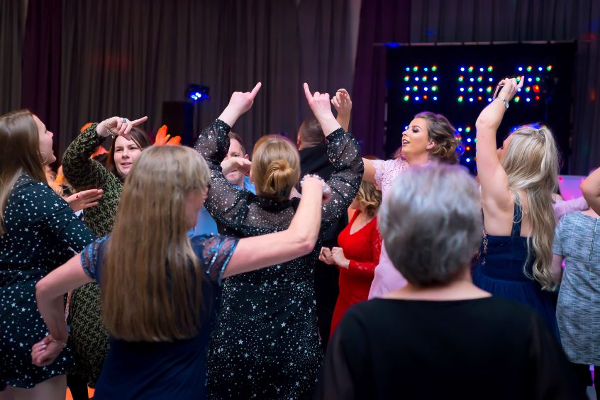 Guests on the dancefloor celebrating during a Christmas party night.