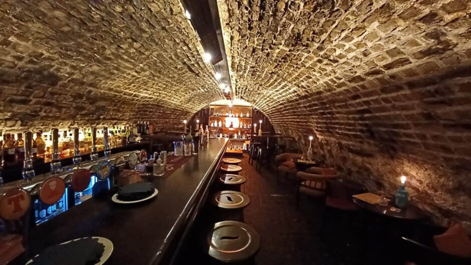 Interior if the Old Workshop Bar inside a brick tunnel at the back of The Ivy Lodge in Aberdeen.
