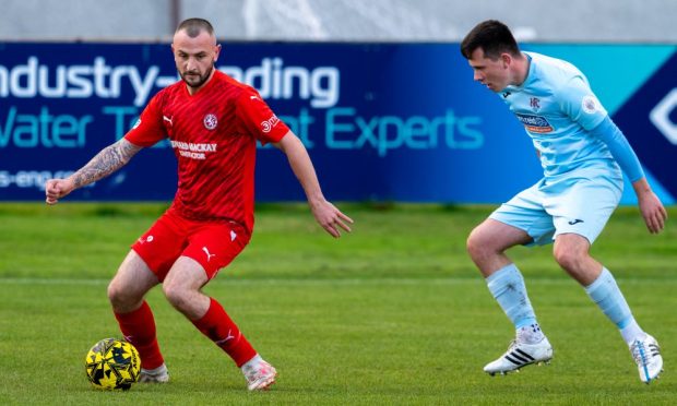 Paul Brindle of Brora Rangers, left, is put under pressure by Connor Killoh of Keith in the GPH Builders Merchants Highland League Cup semi-final at Dudgeon Park.
Pictures by Jasperimage