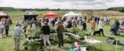 People standing and visiting tents at Chapleton farmers market.