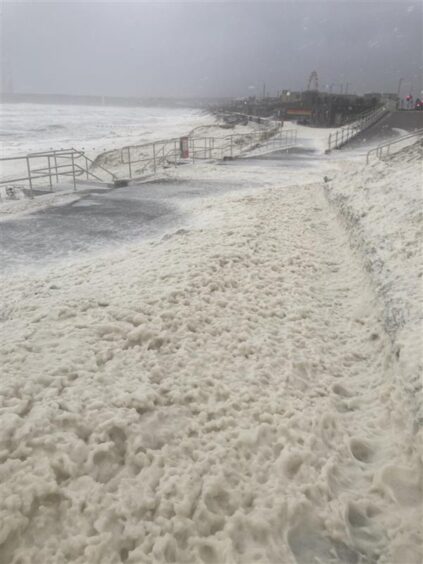 Storm Babet sea foam at Aberdeen beach