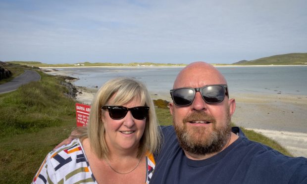 Greg Crawford with his wife Julie on Barra. The pair enjoyed their holiday despite being victims of a bizarre theft. Image: Greg Crawford.