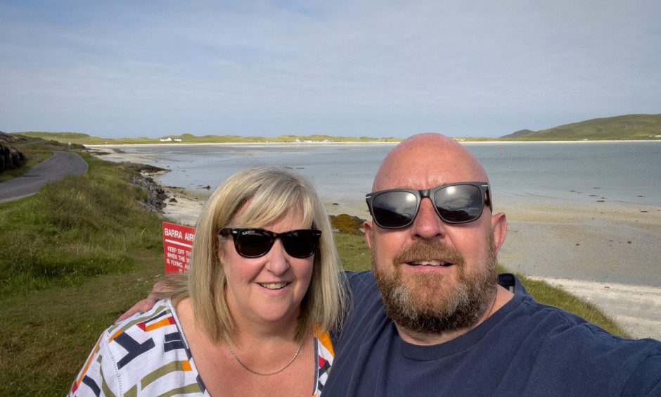 Greg Crawford with his wife Julie on Barra where their camera was stolen.