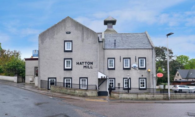 The outside of the Hatton Mill Inn, an old shuttered pub in Aberdeenshire that is now up for sale.