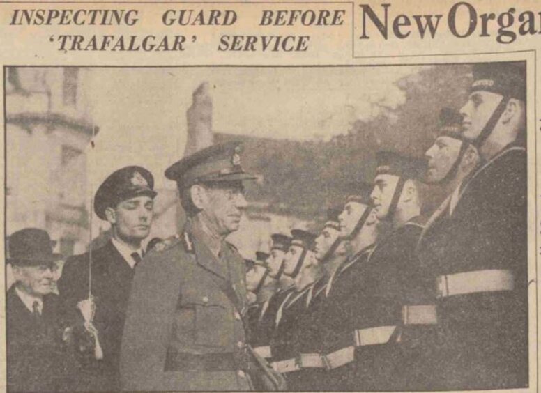 A headline: 'Inspecting guard before Trafalgar service'