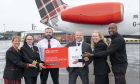 Loganair has been named airline of the year. Claire Forrester, cabin crew, Annag Bagley, captain, Craig Young, first officer, chief executive Jonathan Hinkles, Rebecca Simpson, training captain and Edwin Muzaale, line engineer. Image: Big Partnership
