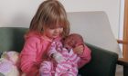 Marina Hilton holding her little sister Emma