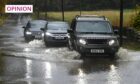 Cars drive through deep floodwater in Westhill during Storm Babet (Image: Kenny Elrick/DC Thomson)