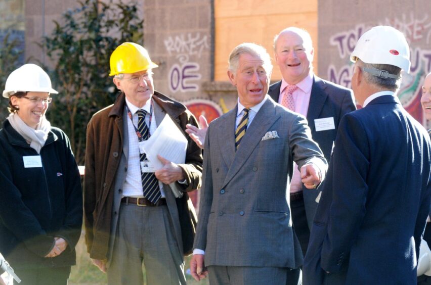 King Charles shared a joke with the travelling architectural circus - including former owner Ian Suttie - at Broadford Works in Aberdeen in 2012. Image: Jim Irvine/DC Thomson
