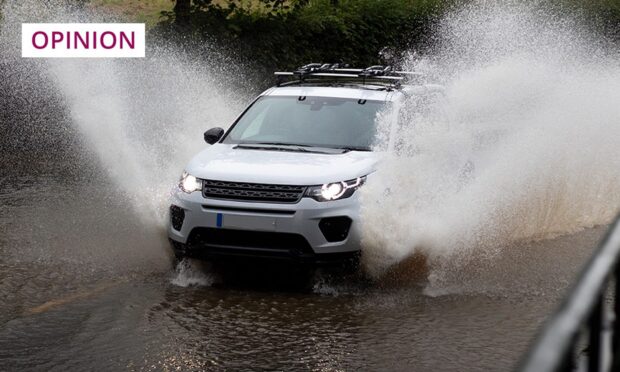 A car driving through floods after heavy rainfall. Image: Shutterstock