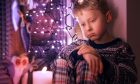 Sad Little boy waiting for Christmas presents