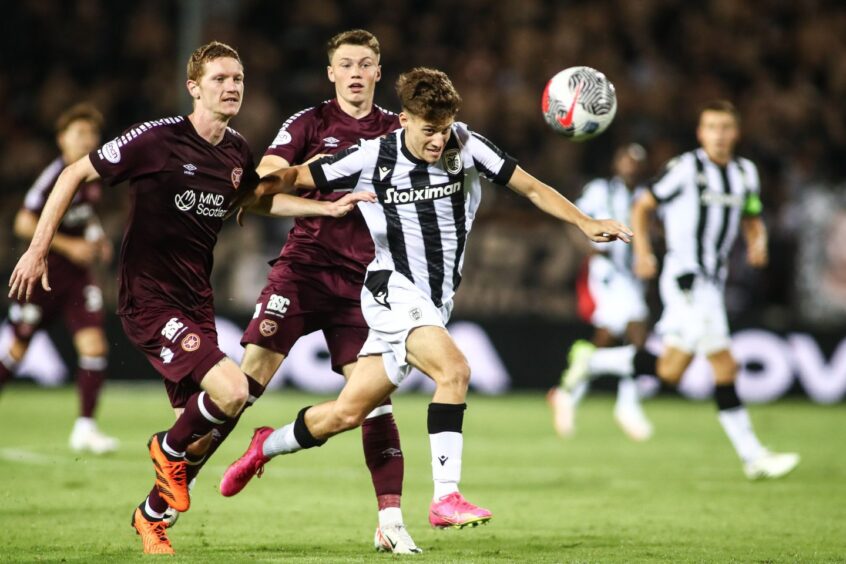 PAOK's Giannis Konstantelias and Hearts's Kye Rowles fight for the ball at Toumba Stadium in the Europa Conference League play-off round second leg.