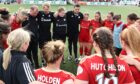 Aberdeen Women manager Clint Lancaster delivers a post-match talk to his squad at Balmoral Stadium