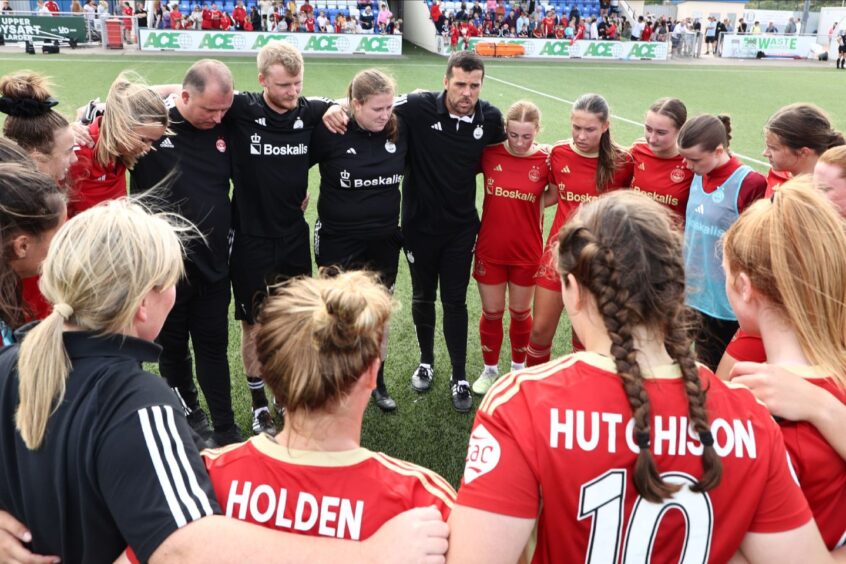 Aberdeen Women manager Clint Lancaster delivers a post-match talk to his squad at Balmoral Stadium