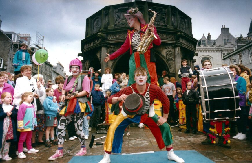 Circus performers entertain a crowd in Aberdeen city centre. Supplied by DCT Archives.