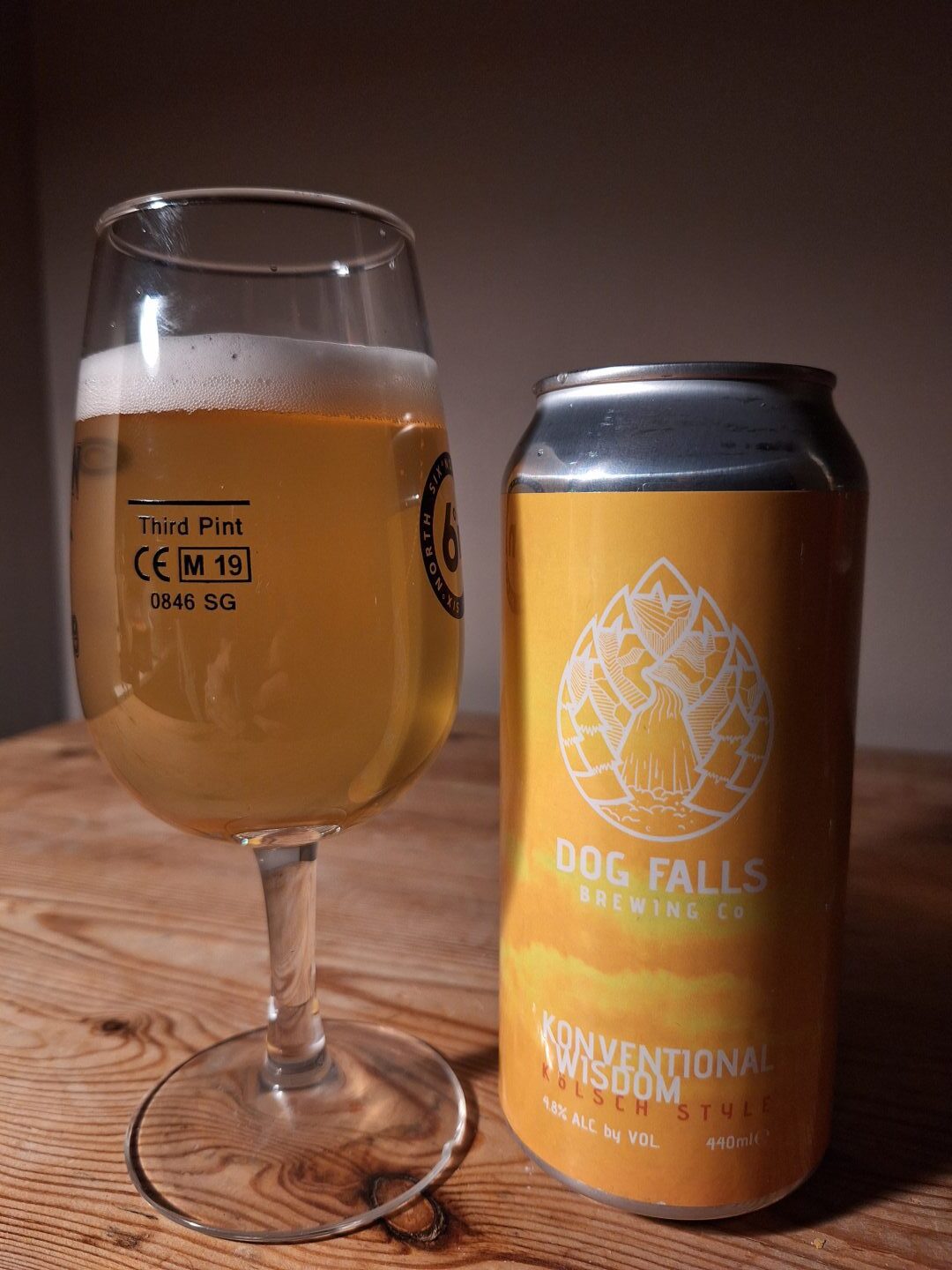 A glass of the Dog Falls kolsch beer, next to its can. 