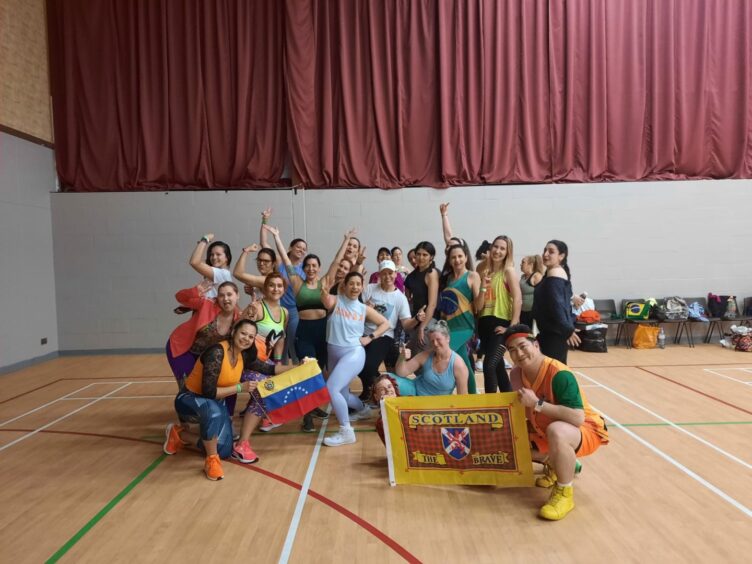 The zumba class in Aberdeen grouped together and posing for the camera