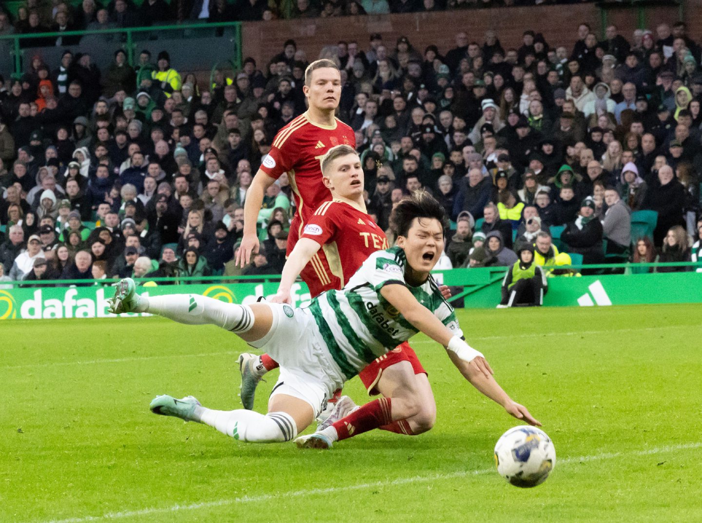Celtic's Oh Hyeon-Gyu is taken down in the box by Aberdeen's Jack MacKenzie.