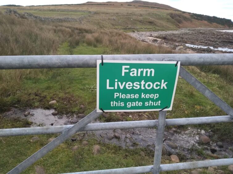 Warning sign on gate that reads: 'Farm Livestock - Please keep gate shut'