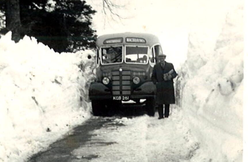 A photo of David MacBrayne's bus is driving through more 10 ft of snow on either side near Gorthleck, Inverness in 1946's winter.