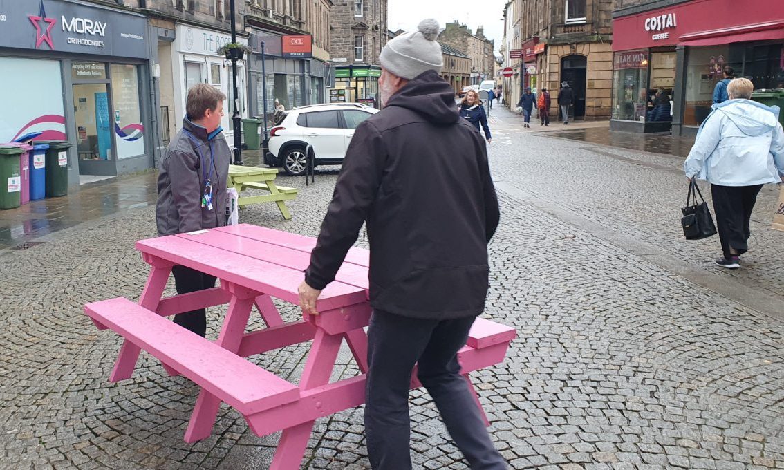 Willie and Sam moving bench outside Costa. 