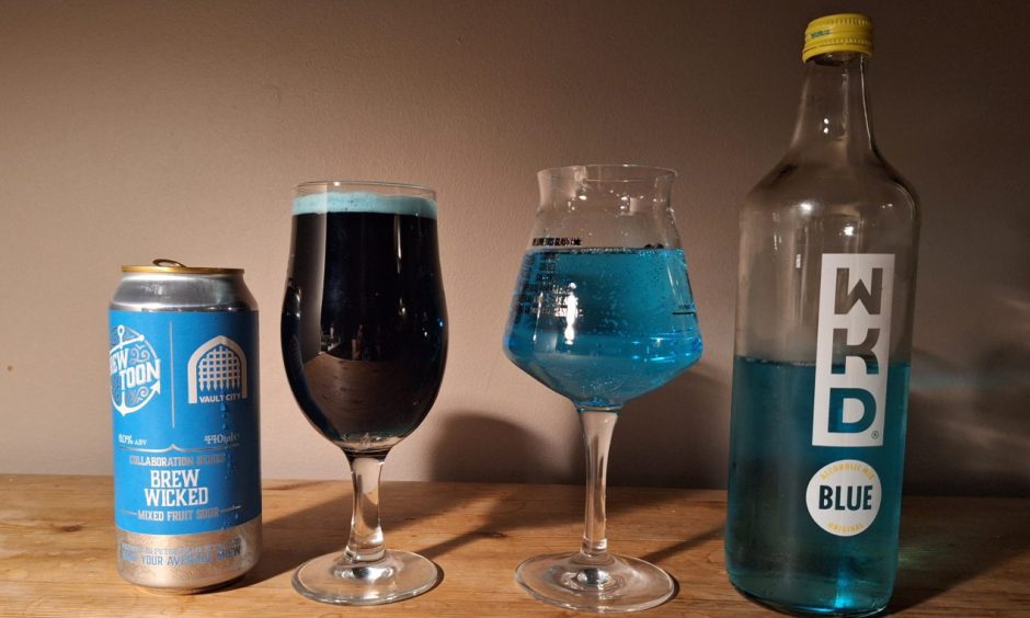 Bright blue beer from Vault City in a glass, next to a glass of Blue WKD. 