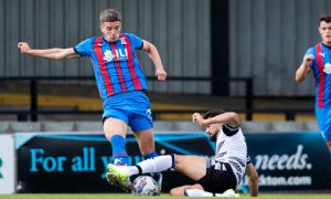 Inverness midfielder Charlie Gilmour is challenged by Ayr's Ben Dempsey.