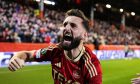 Aberdeen's Graeme Shinnie celebrates Dante Polvara's goal to make it 2-0 during a UEFA Europa Conference League match against PAOK. Image; SNS