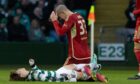 Aberdeen's Slobodan Rubezic and Celtic's Kyogo Furuhashi after colliding heads during the cinch Premiership match at Celtic Park on Sunday. Image: SNS.