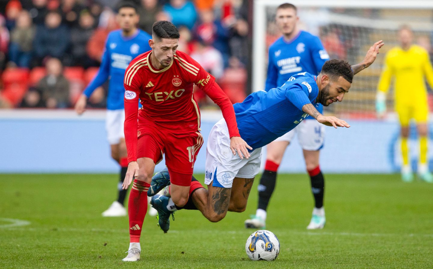 Aberdeen's Ester Sokler wins the ball from Rangers' Connor Goldson at Pittodrie on his first start for the Dons. Image: SNS 