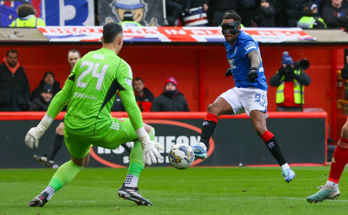 Aberdeen's Kelle Roos makes a save from Rangers' Danilo at Pittodrie. Image: SNS