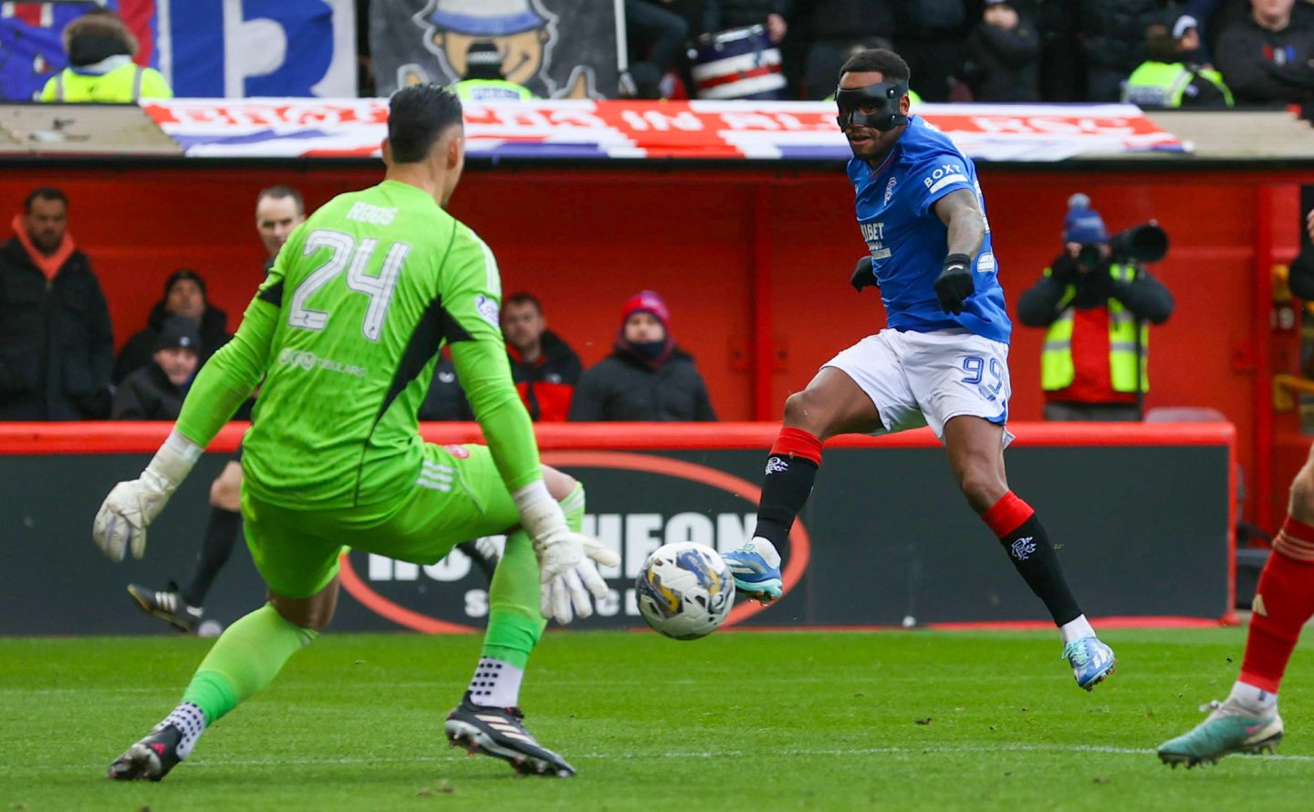 Aberdeen's Kelle Roos makes a save from Rangers' Danilo at Pittodrie. Image: SNS 