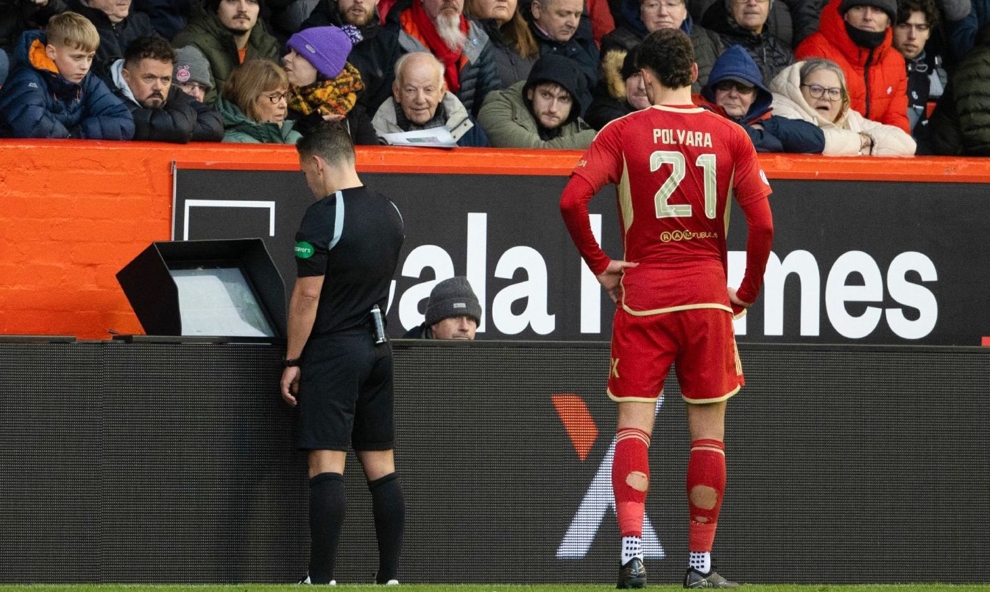 Referee Nick Walsh checks VAR before awarding Rangers a penalty against Aberdeen. Image: SNS