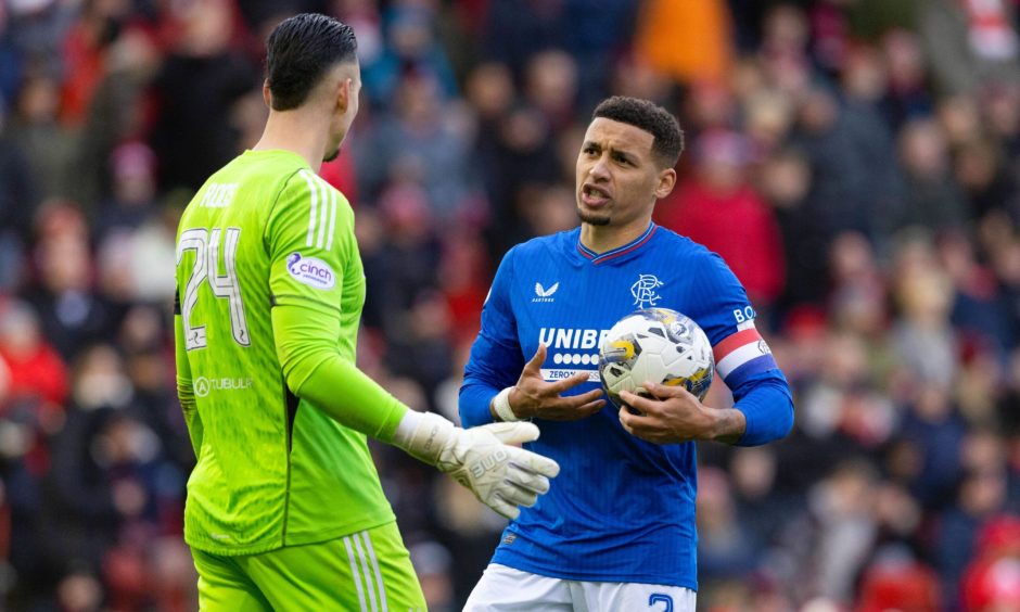 Rangers' James Tavernier speaks to Aberdeen's Kelle Roos before taking a penalty during the 1-1 Premiership draw at Pittodrie. Image: SNS. 