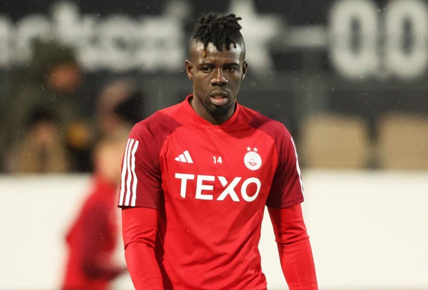 Aberdeen's Pape Gueye warms up before the match in Helsinki. Image: SNS.