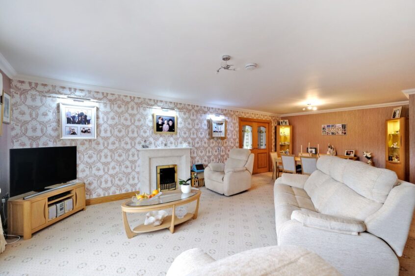 Spacious living area with neutral decor in the Inverurie property.