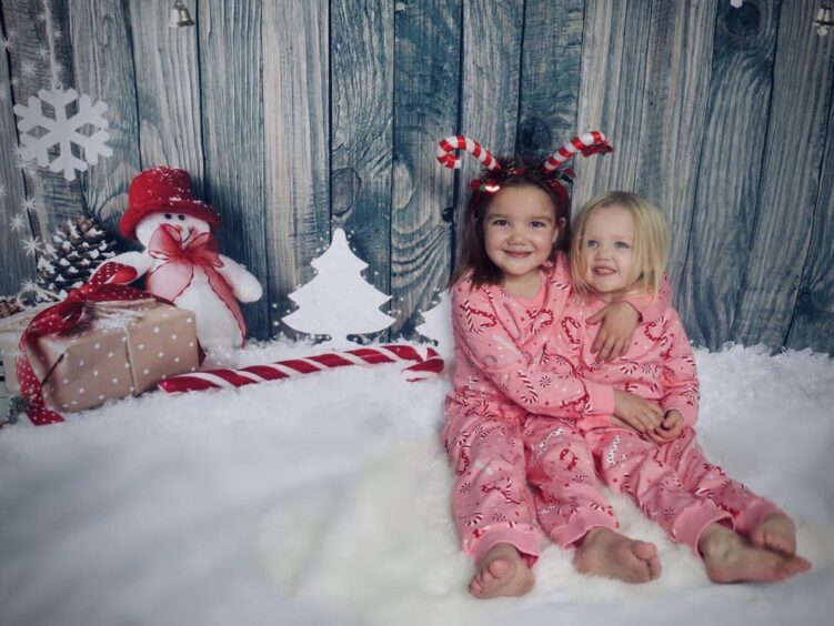 Sisters Josie and Adeline Davidson pictured wearing matching Pajamas' during a Christmas themed photo shoot. 