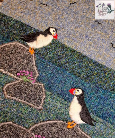 A close-up of puffins embroidered onto Harris Tweed.