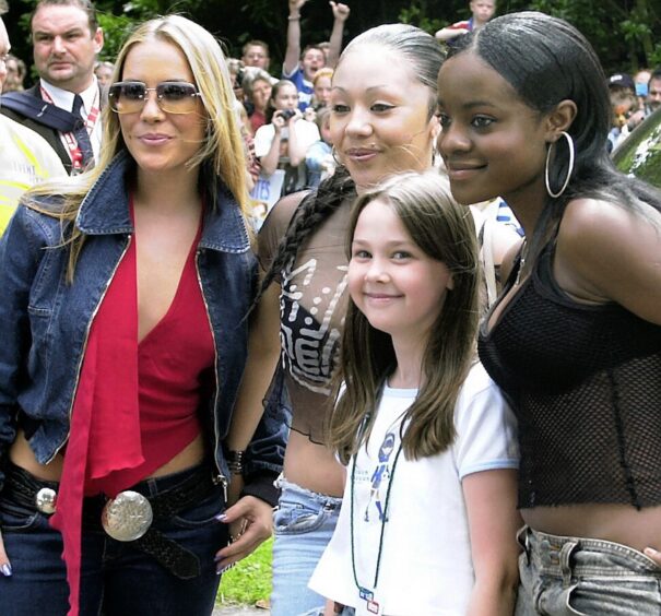 The Sugababes pose with a fan before the show. Supplied by DCT Archives.