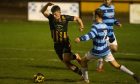 Huntly's Lewis Crosbie, left, tries to get away from Banks o' Dee's Michael Philipson. Pictures by Jasperimage