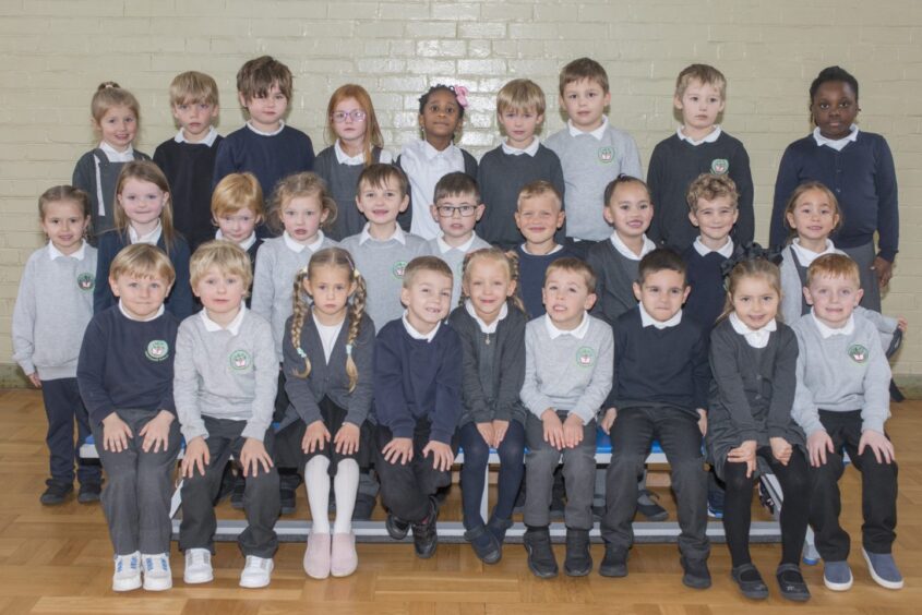 P1 and P1-2 at Abbotswells Primary School in tree long rows in the hall